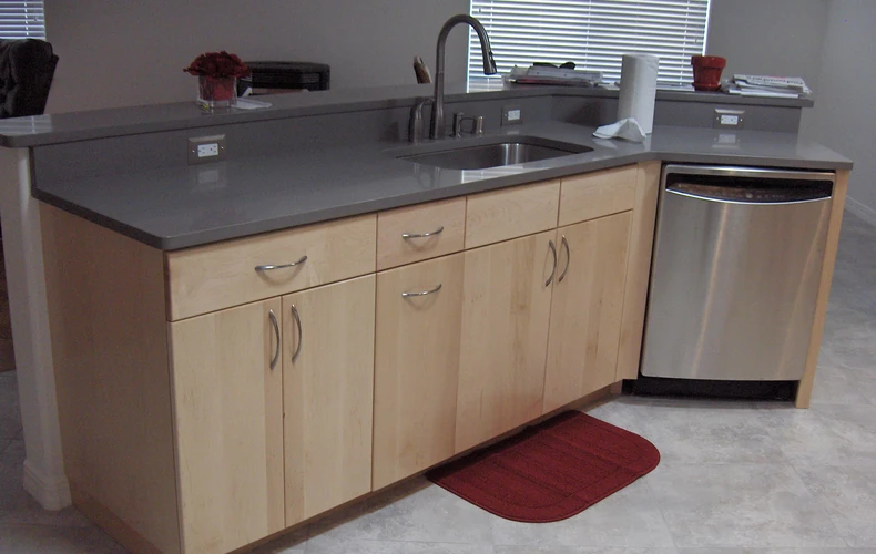 Maple kitchen island with quartz countertops and framless cabinets