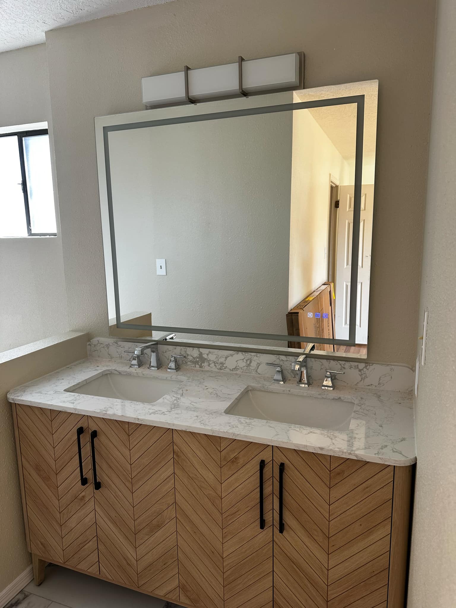 Custom bamboo vanity and illuminated mirror in Rio Rancho home