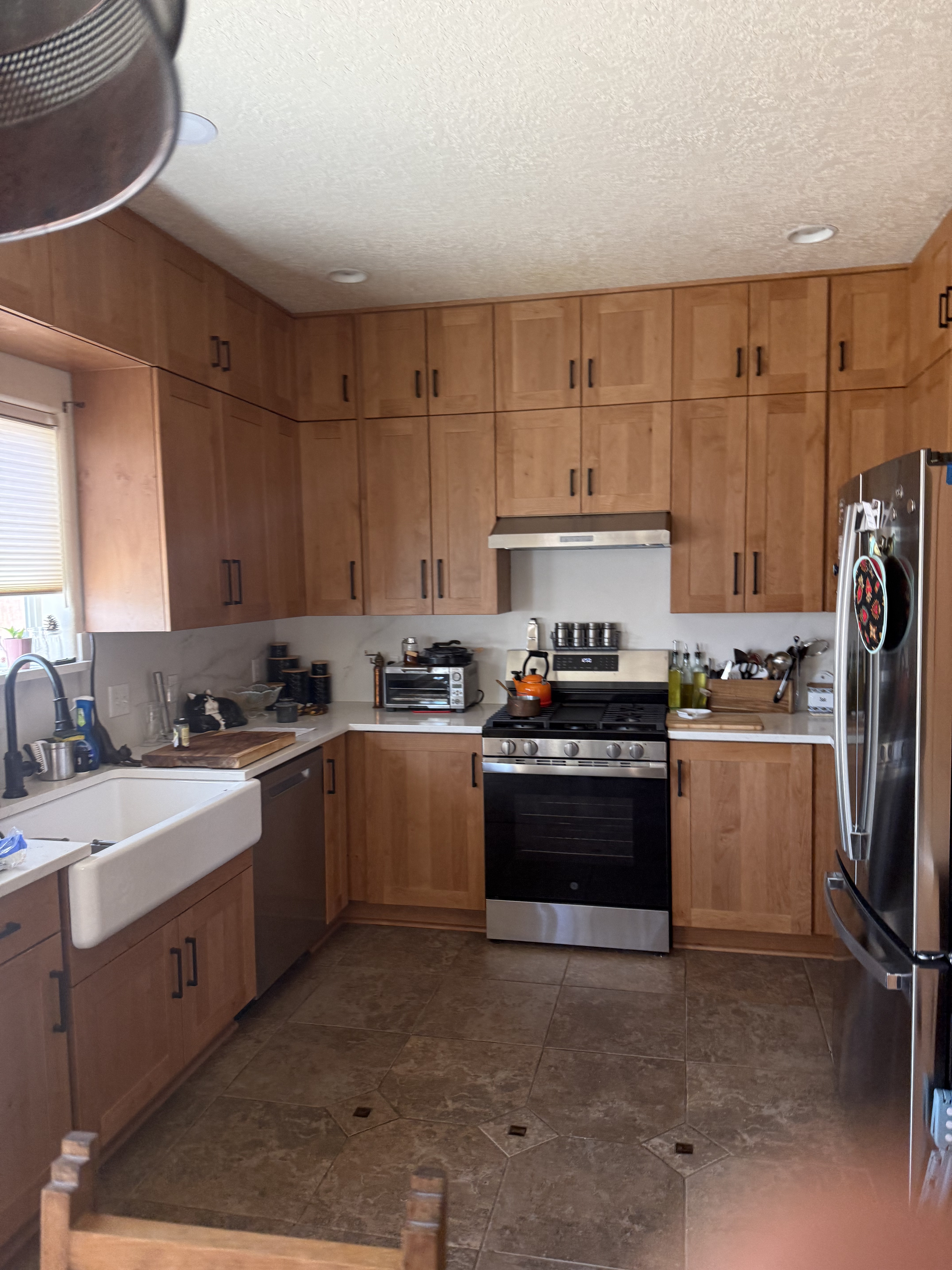 full stack framless oak cabinetry with quartz counters and a cast iron apron sink completed by KRCS in Santa Fe