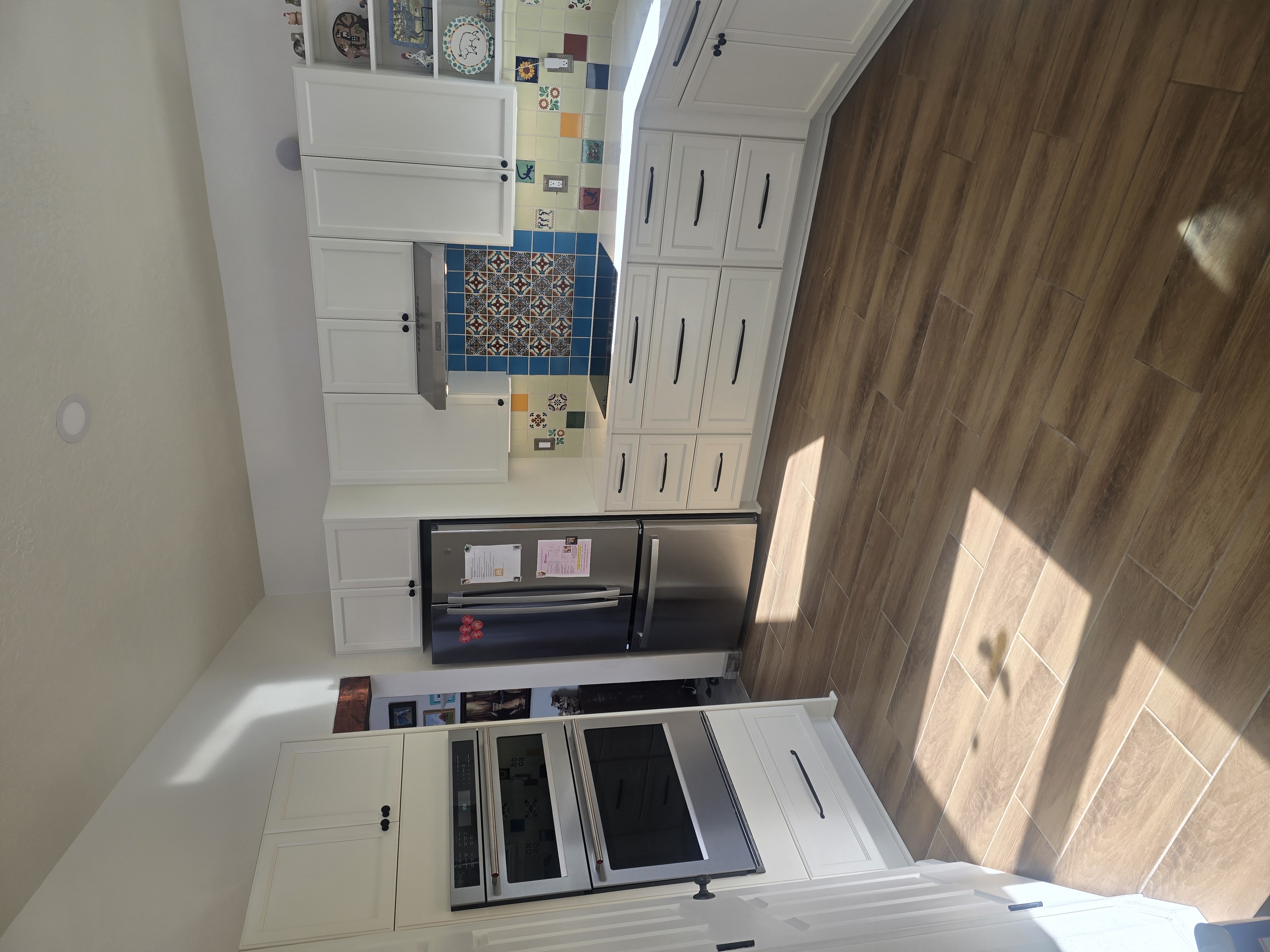 White shaker cabinetry with regional Talavera tile backsplash completed by KRCS in Santa Fe