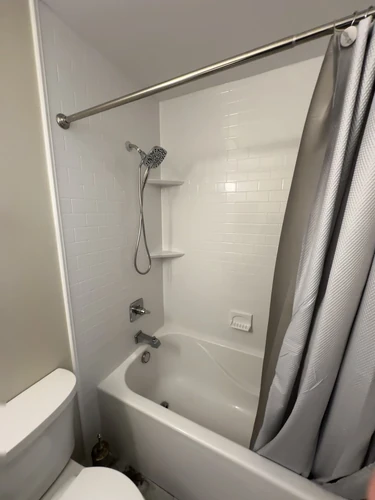 stylish deep-soak bath-tub with subway pattern surround in white