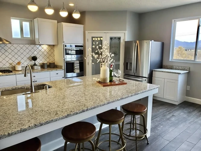 Renovated kitchen with granite island and custom cabinetry